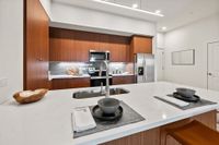 Luna at Viera Luxury Studio Apartments Viera FL - Luna At Viera - Kitchen Featuring Custom Cabinets, Quartz Countertops, And Stainless-Steel Appliances