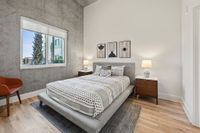 Luna at Viera Modern bedroom with accent wall and wood-style flooring