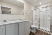 Primary bathroom with double vanity and walk-in shower