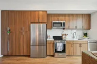 Studio kitchen with wood cabinets