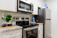 Tradition at Palm Aire Kitchen with white cabinets and stainless steel appliances