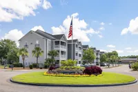 Exterior of community with flag and roundabout