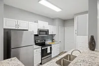 Kitchen with white cabinets and stainless steel appliances
