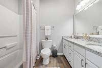 Bathroom with shower/tub combo and double vanity