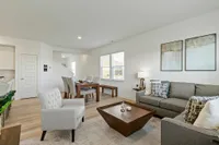 Townhomes Near Quaker Park - Casey Corner - Living Area With Wood-Style Flooring and Open Concept Design.