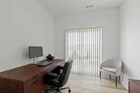 Spare room and office with desk and chairs
