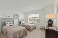 Guest bedroom with two twin beds and dresser