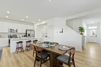 furnished kitchen and dining area with wood style flooring