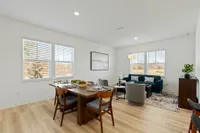 furnished dining and living area with wood style flooring