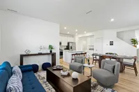 Furnished living area overlooking dining and kitchen area