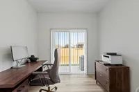 Furnished office with desk and drawer and sliding glass door
