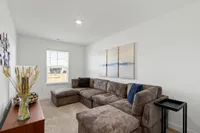furnished loft area with carpet