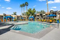 sparkling pool with shaded cabanas