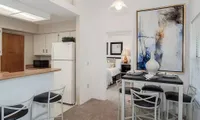 view of bedroom through kitchen with dining table