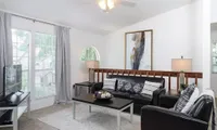 living room with black couch and coffee table