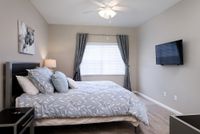 Guest bedroom with bed and TV