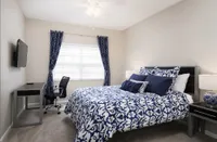 Guest bedroom with bed and desk