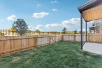 North Austin, TX, Townhomes, with In-Unit Washer and Dryer - Lone Oak Homes - Backyard With Privacy Fence, Green Lawn, Covered Patio Slab, And Open Sky Views.