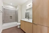 Bathroom with tub and large vanity with storage