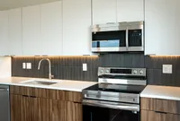 kitchen with sleek dark tile backsplash