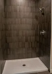 spacious standing shower with upscale tiling