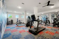 fitness center with cardio equipment and free weights