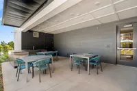 poolside kitchen with dining tables
