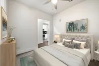primary bedroom with carpet and ceiling fan
