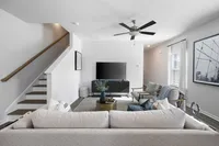 modern furnished living area next to staircase
