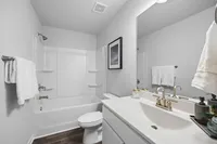 guest bathroom with shower tub combo