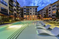 Swimming pool with tanning deck at sunset
