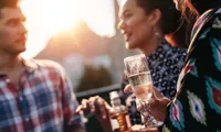 people standing with drinks in hand