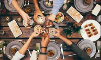 aerial shot of poeple toasting over dinner