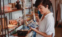 Girl reading a book in a shop