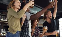 friends cheering holding drinks
