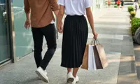 couple shopping outdoors holding hands