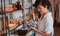 woman looking at item in shop