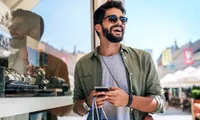 man smiling and shopping outdoors