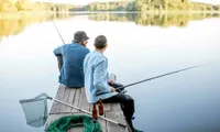two men fishing on a lake