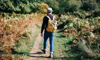 man walking on a walking trail