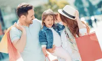 Joyful family with shopping bags enjoying a day out.