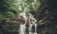 Woman in front of a waterfall