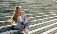 Girl sitting on steps in blazer
