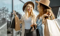 two women in stylish hats shopping
