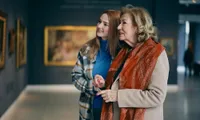grandmother and granddaughter viewing art in a gallery