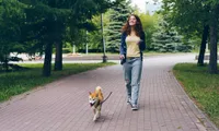 woman walking dog at park