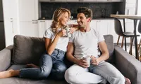 A couple in their home drinking coffee