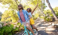 man and woman on a bike on a trail