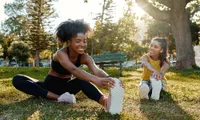 women stretching in a park