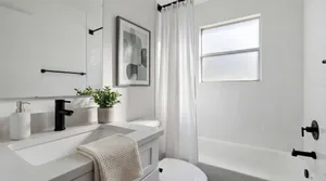 Bright and elegant bathroom featuring sleek fixtures, modern design, and abundant natural light.